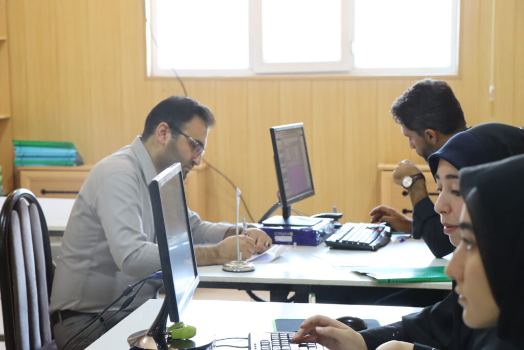 Afagh staff supporting students in an academic office